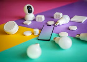 Smart devices arranged on colorful background showcasing modern technology options.